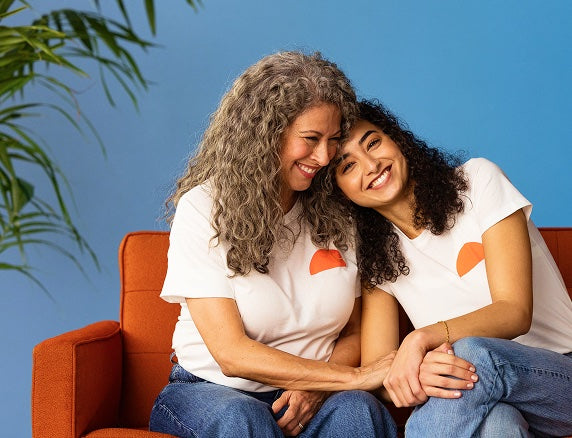 mom and daughter head on shoulder