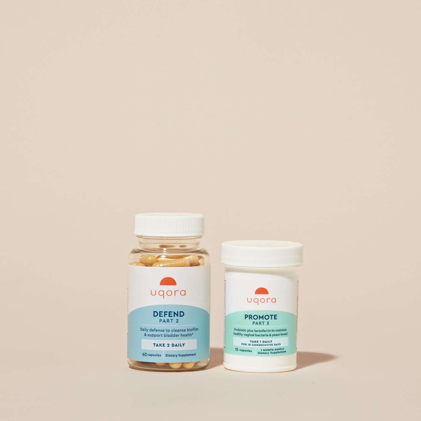 A clear plastic jar with pills and a 'Uqora Defend' label, and a plastic pill bottle with a 'Uqora Promote' label