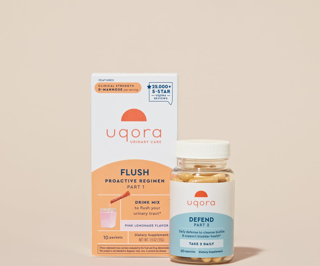 A box of packets that says 'Uqora Pink Lemonade' Flush, and a bottle with pills that says 'Uqora Defend'