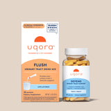Uqora Unflavored Flush box and Defend bottle on tan background