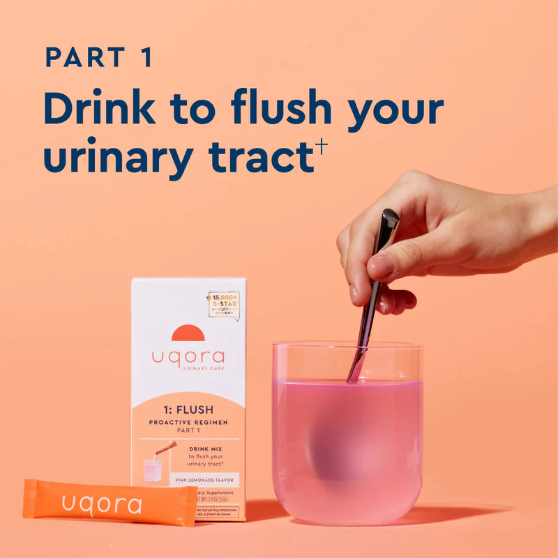 Hand stirring Uqora Pink Lemonade Flush in glass