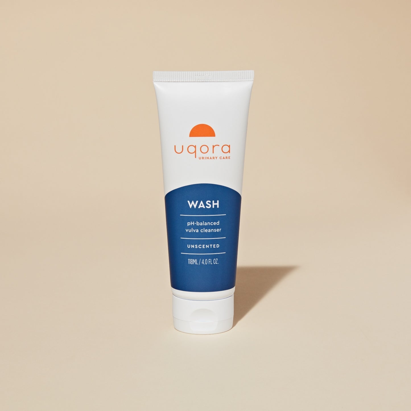 A 118 mL tube of pH-balanced vulva cleanser labeled "Uqora Wash," standing upright on a beige background.