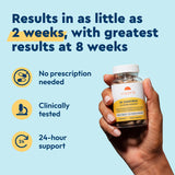 Hand holding a supplement bottle with text about product benefits on a blue background